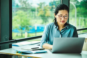 female-student-sitting-in-front-of-a-laptop