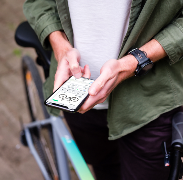 mockuuups-typing-on-an-iphone-11-pro-mockup-whilst-stood-with-a-bike 2.png