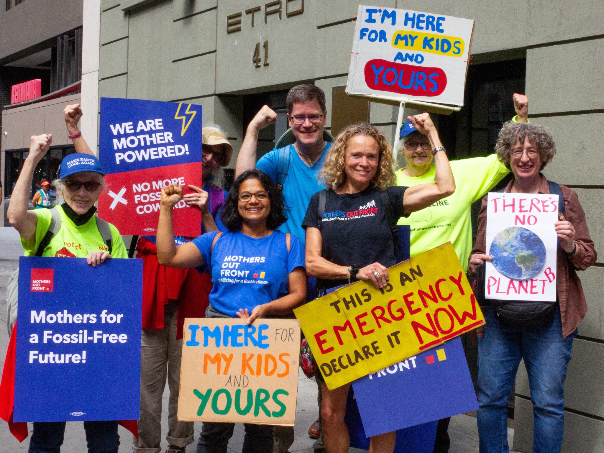 A group of volunteers at a climate rally with the organization Mothers Out Front