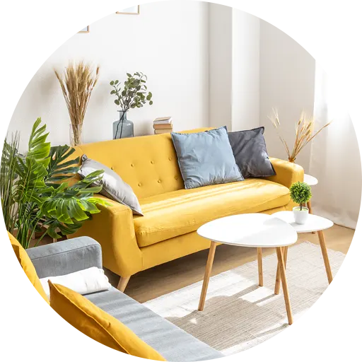 A bright and modern living room with a yellow sofa, cozy cushions, and stylish decor.