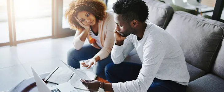 Two people reviewing finances and credit card debt together.