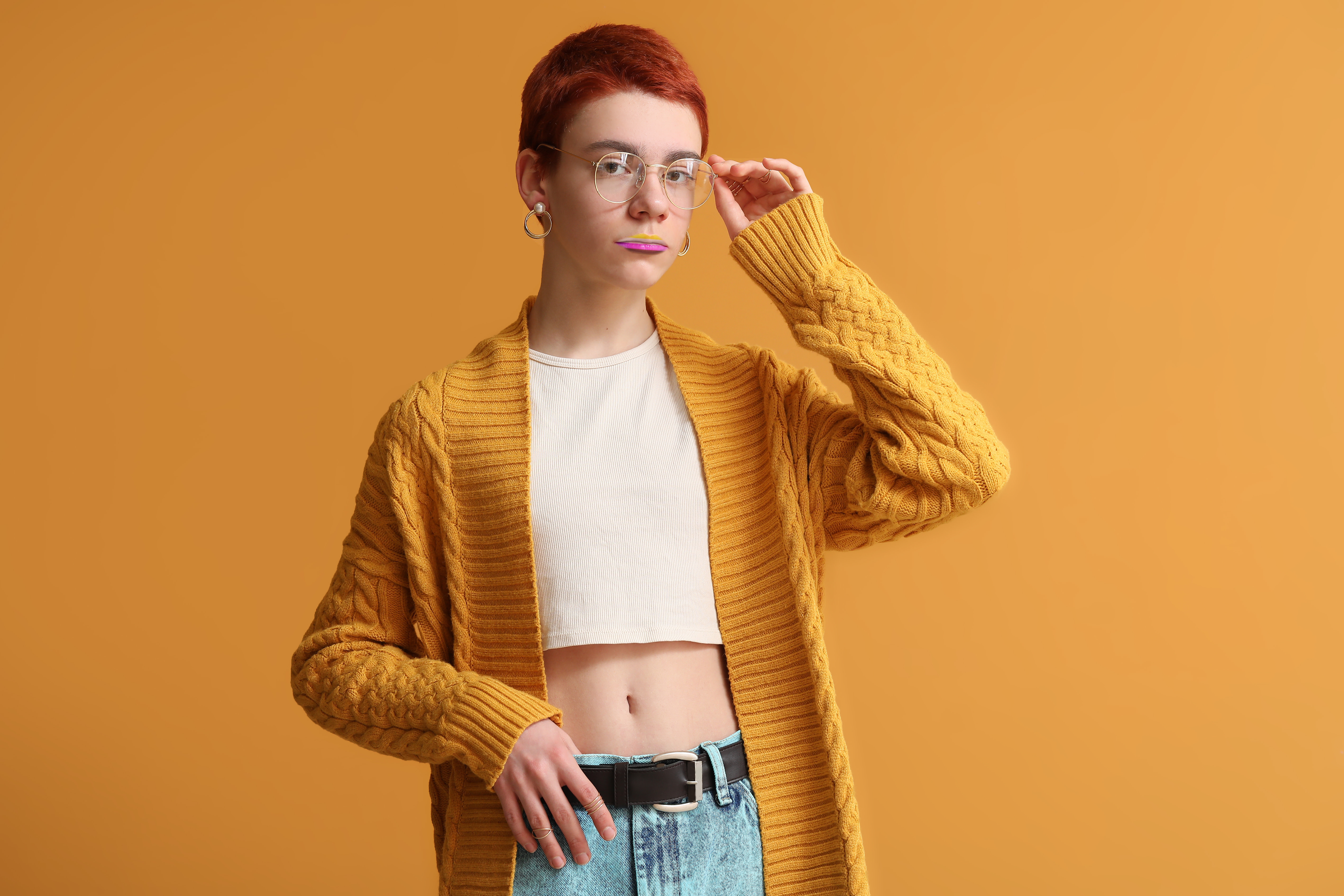 Non-binary teenager on color background