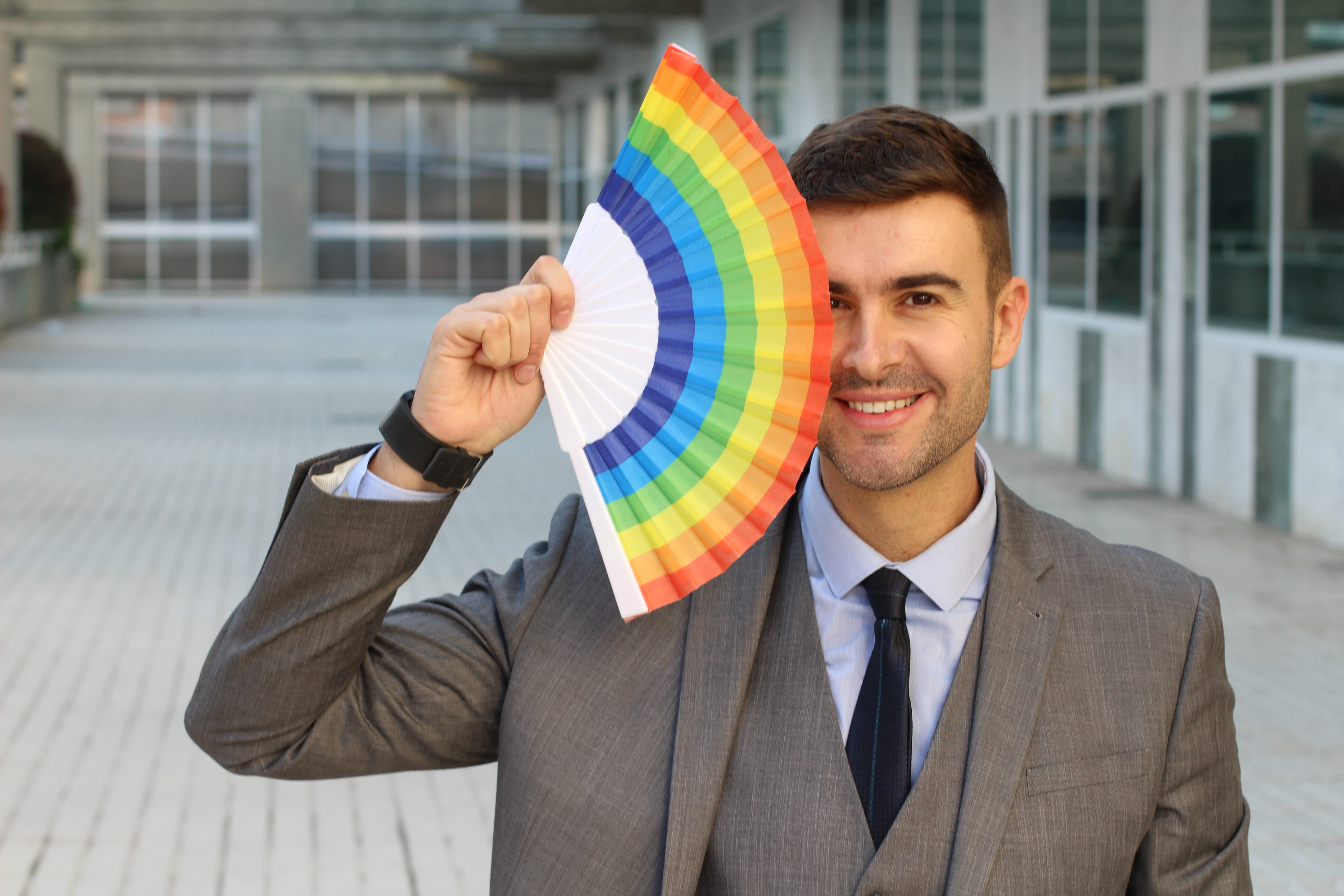 Elegant man waving a gay fan