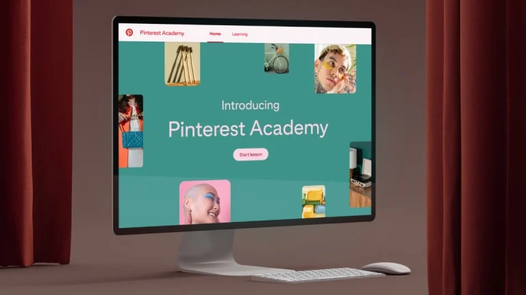 Desktop computer featuring a mock-up of the Pinterest Academy homepage.