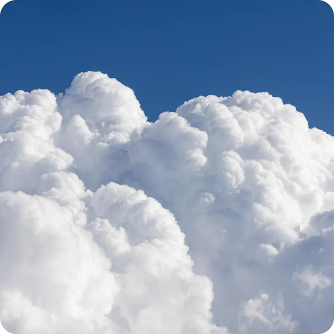 A photo of fluffy white clouds in the sky.