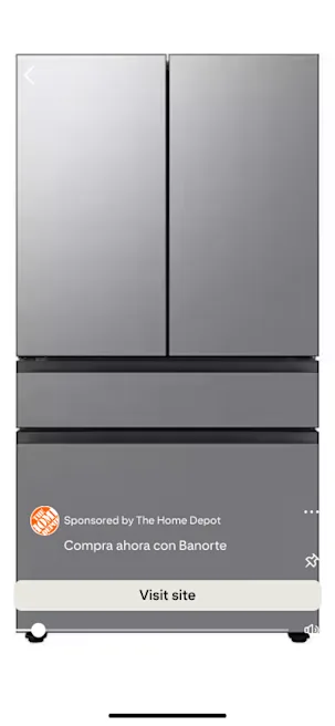 A sleek silver refrigerator with double doors on top and two drawers below. The Home Depot ad overlay reads "Compra ahora con Banorte."