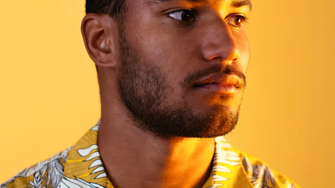 A man wearing a yellow shirt