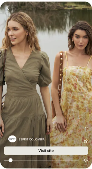 2 women wearing casual dresses in front of a lake.