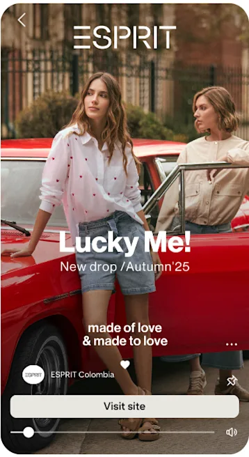 2 women wearing casual Esprit outfits in front of a classic red car.