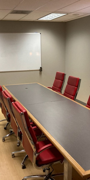 A conference room with red chairs at Legacy Office Center.