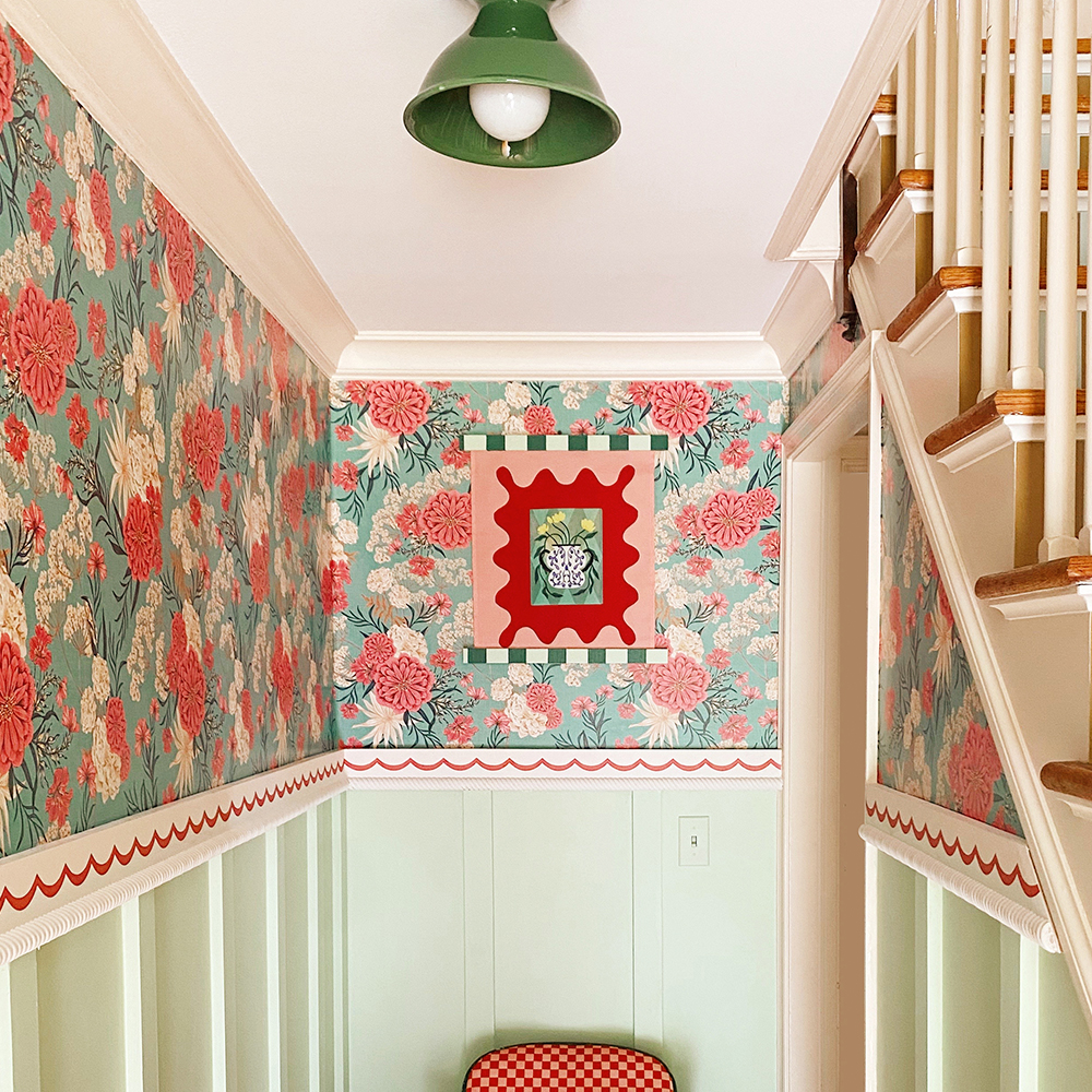 Hall area with pink and teal floral wallpaper.