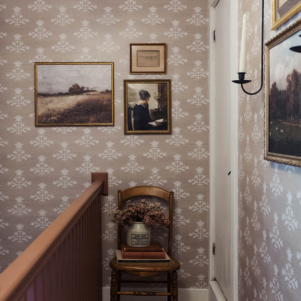 Hallway with pinkish neutral grasscloth wallpaper.