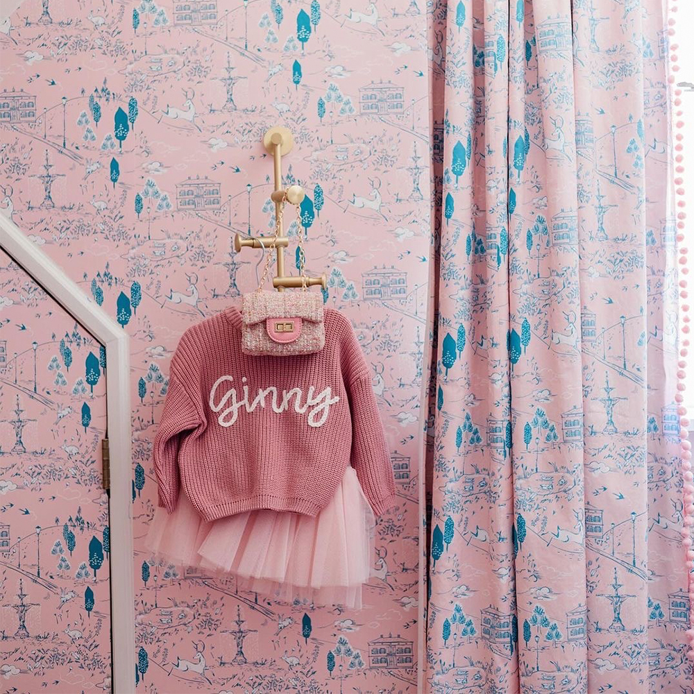 Pick toile wallpaper and curtains in a nursery.