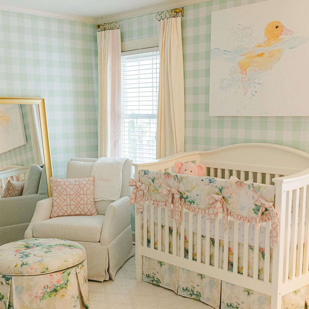 Nursery with green gingham wallpaper floral upholstery and a duck painting.