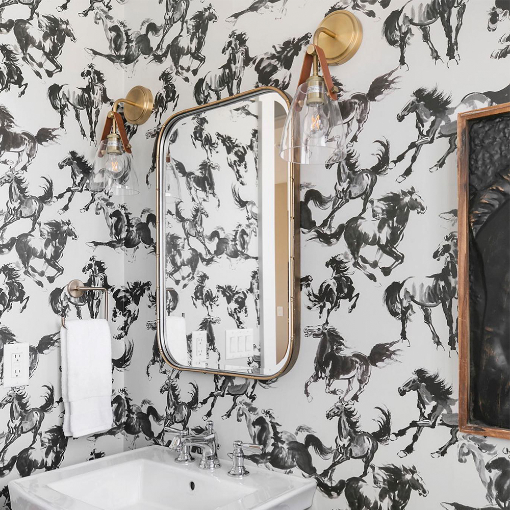 Bathroom with black and white wild horses wallpaper.