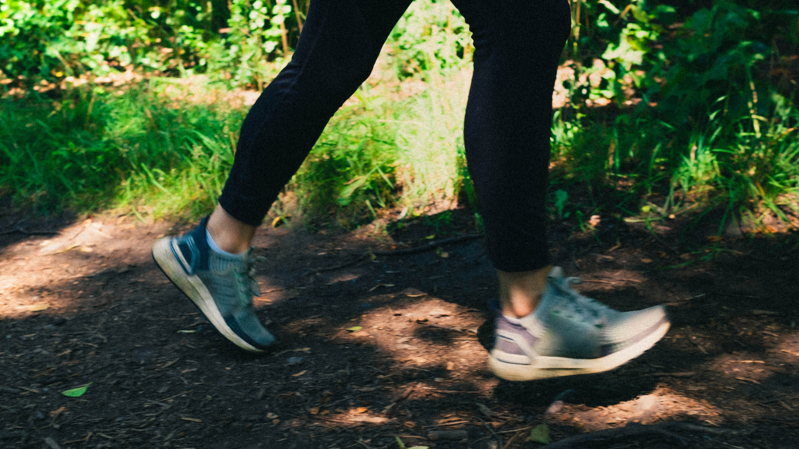 Woman jogging in the woods in trainers