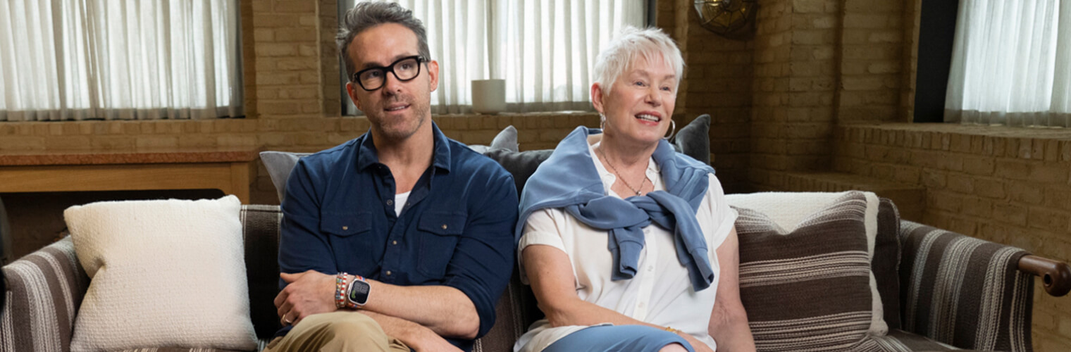 Ryan Reynolds sitting with his mother during an interview