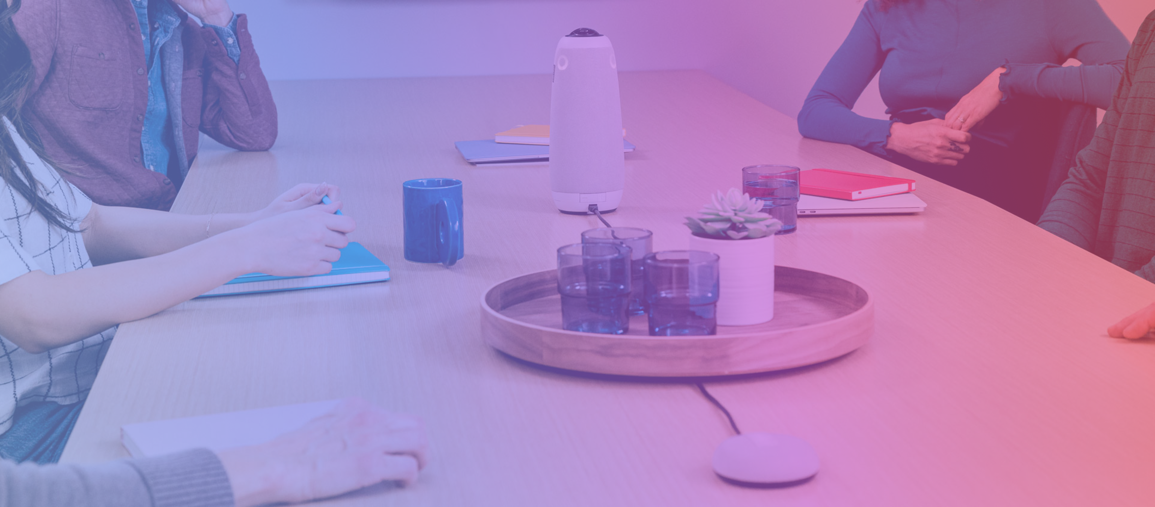 Meeting Owl 3 video conferencing device and Expansion Mic in a meeting room