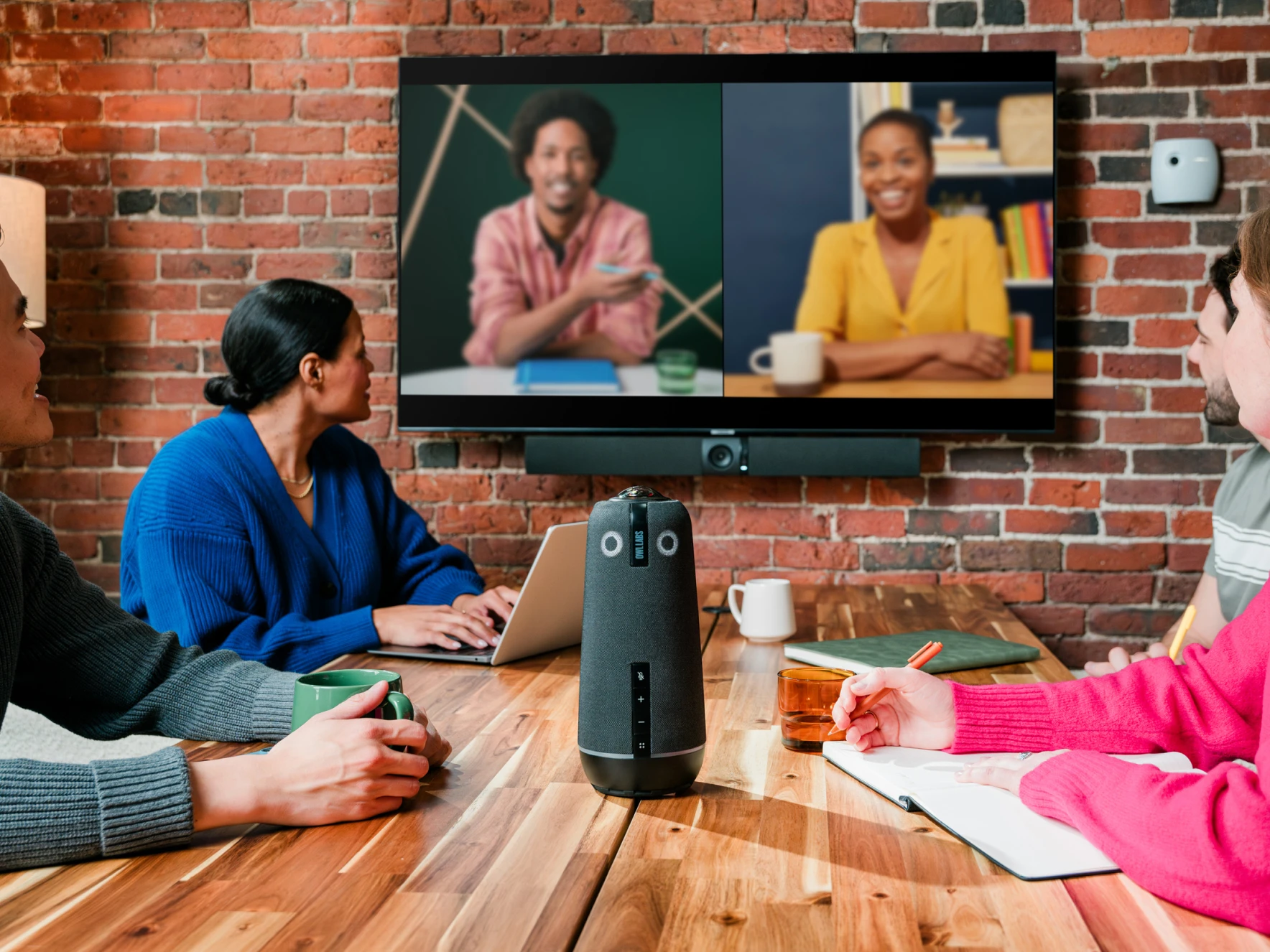 Meeting Owl 4+ and Owl Bar featured in a hybrid conference room with on-site and remote participants