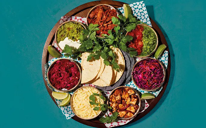 Aerial shot of a Taco Sharing Board on a blue background Aerial shot of a Taco Sharing Board on a blue background