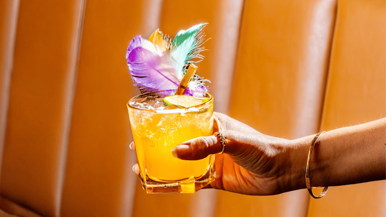 A woman holding a decorative cocktail A woman holding a decorative cocktail