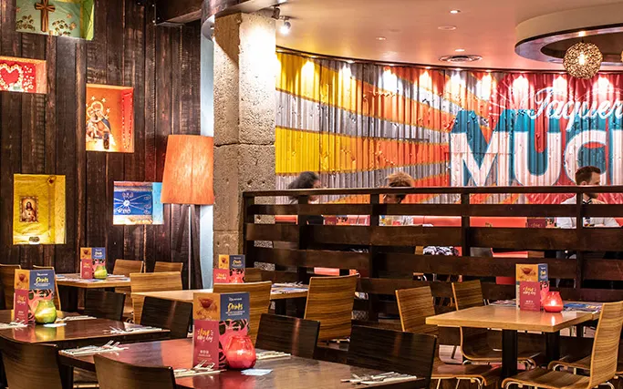 Wood panelled wall and large colourful mural at Las Iguanas Deansgate Wood panelled wall and large colourful mural at Las Iguanas Deansgate