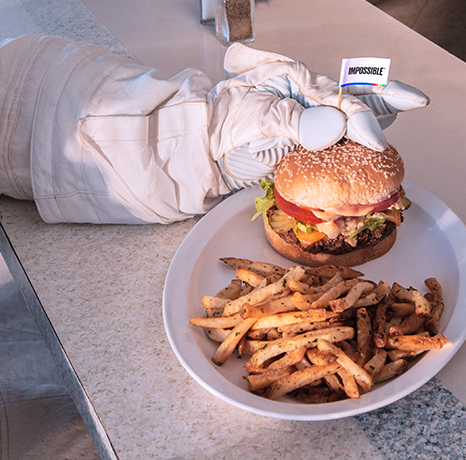 Mission Still AstronautHand wBurger 466x460