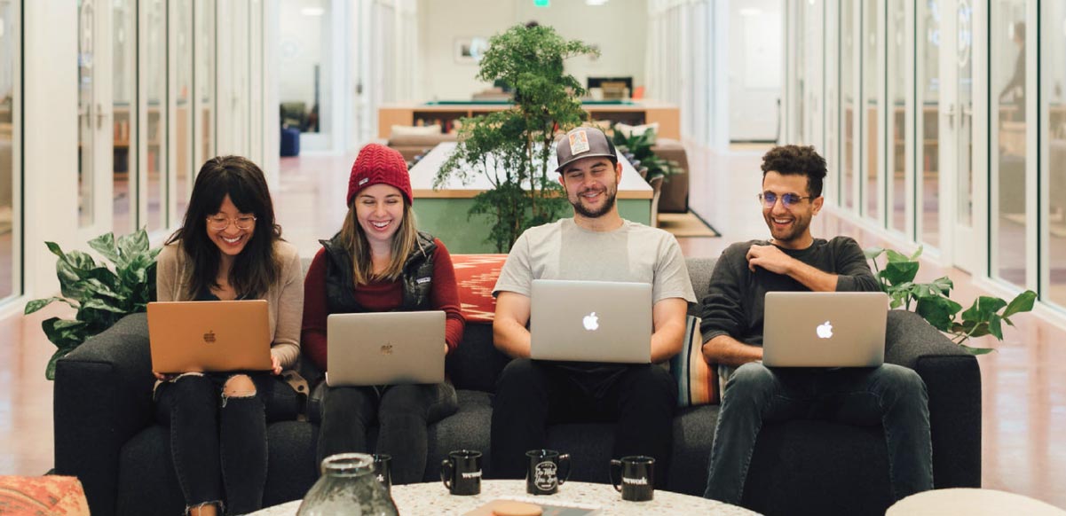 Four students learning together at a Flatiron School campus