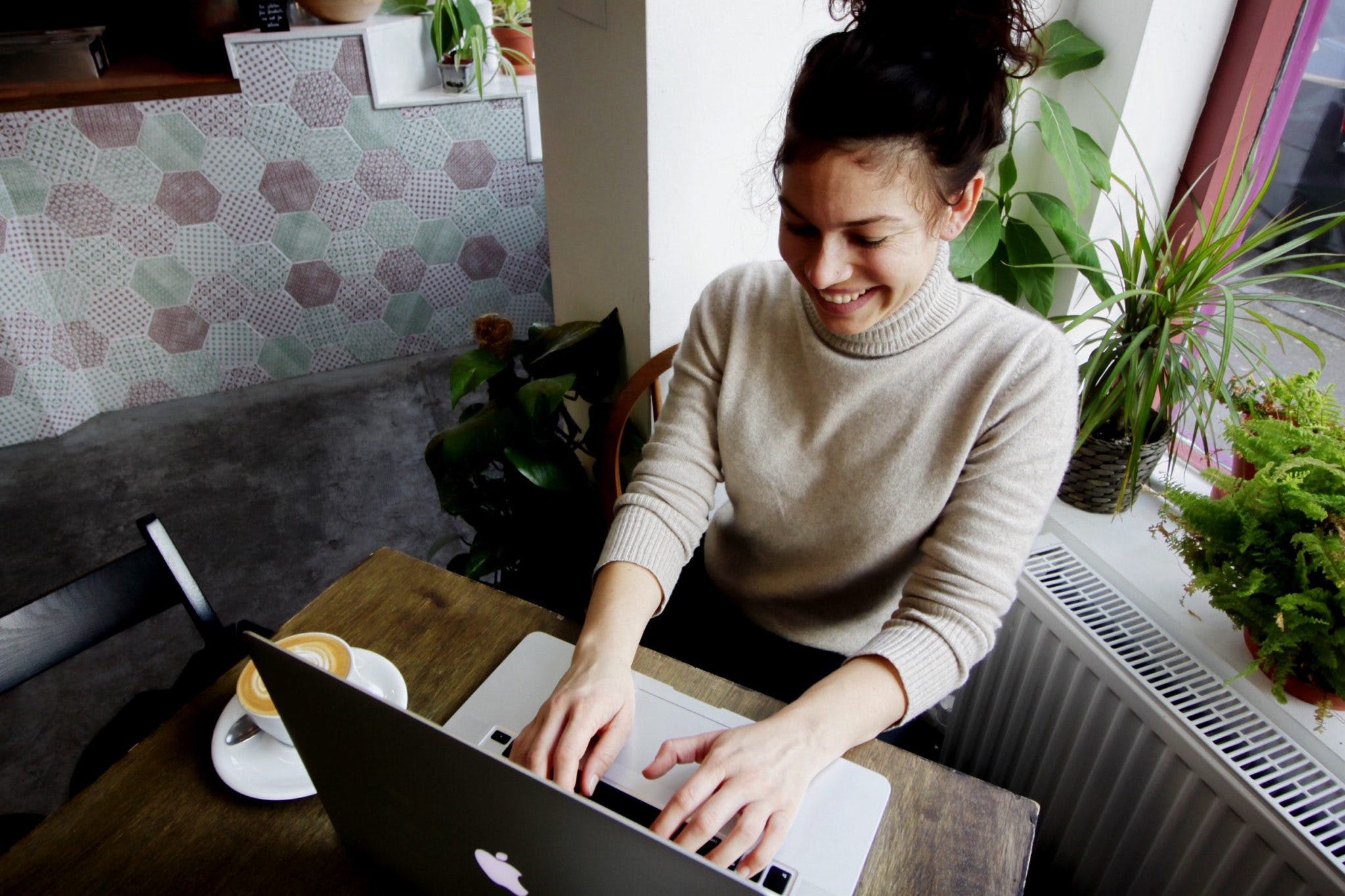 girl in turtleneck on computer