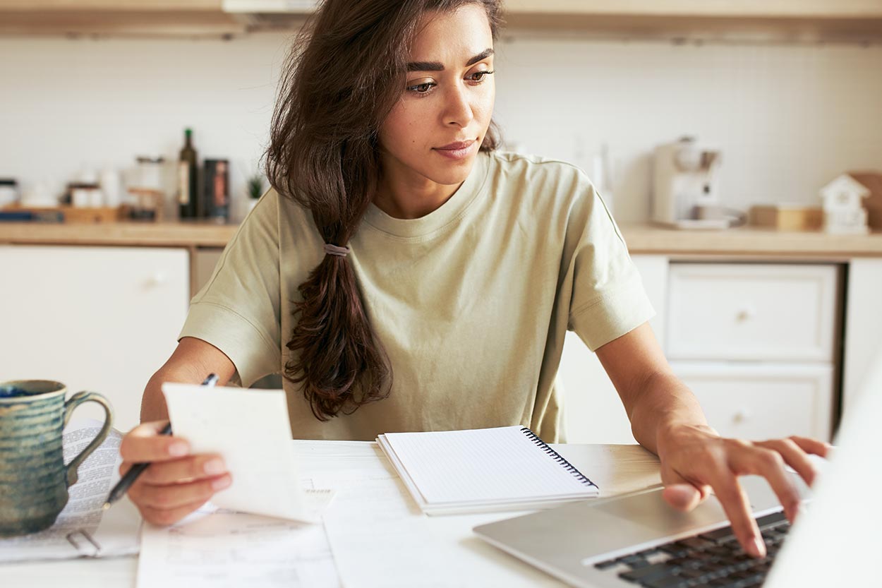 female student at computer looking at a budget