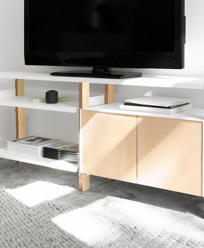 TV shown on Media Console demonstrates the continuous top shelf which allows for a TV to sit directly in the center of the unit.