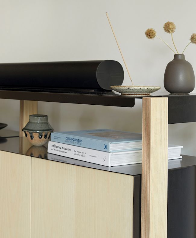 The Media Console shown with a sound bar sitting across the top shelf.