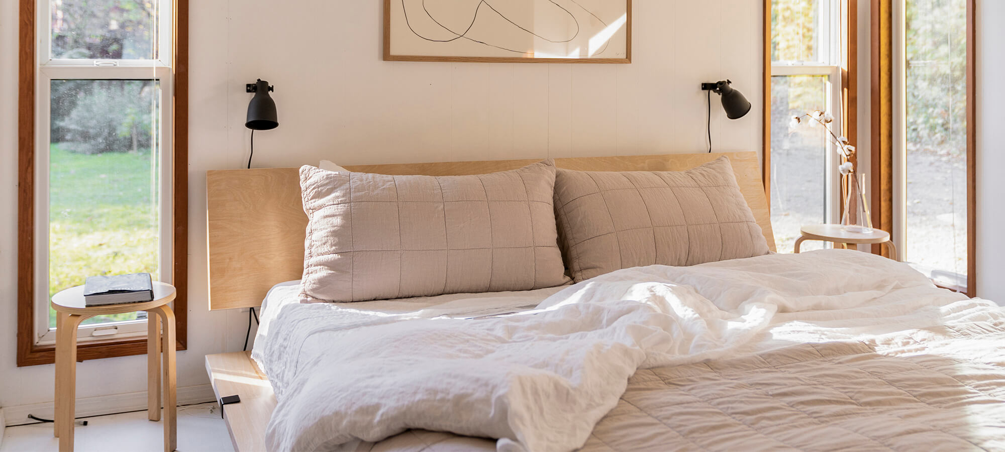 A bedroom with a Floyd Bed Frame.