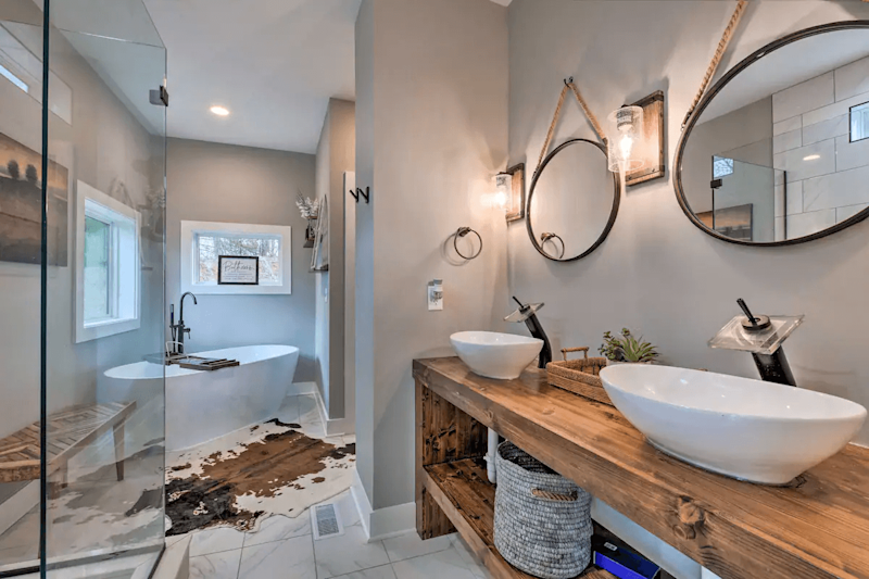 Master bathroom with stand-alone tub, individual sinks, individual vanity mirrors.