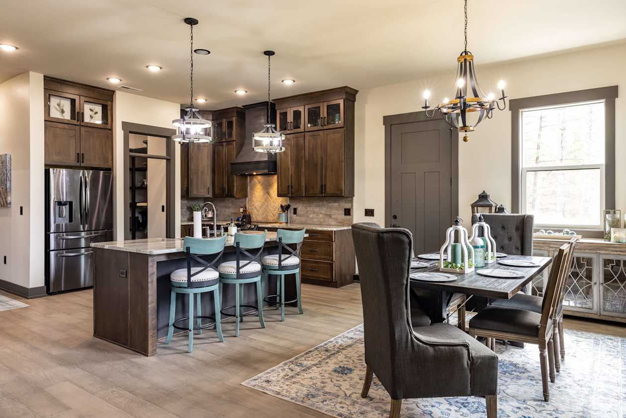 Beautiful finishes and custom lighting make the kitchen and dining room in the Chadwell home feel spacious.