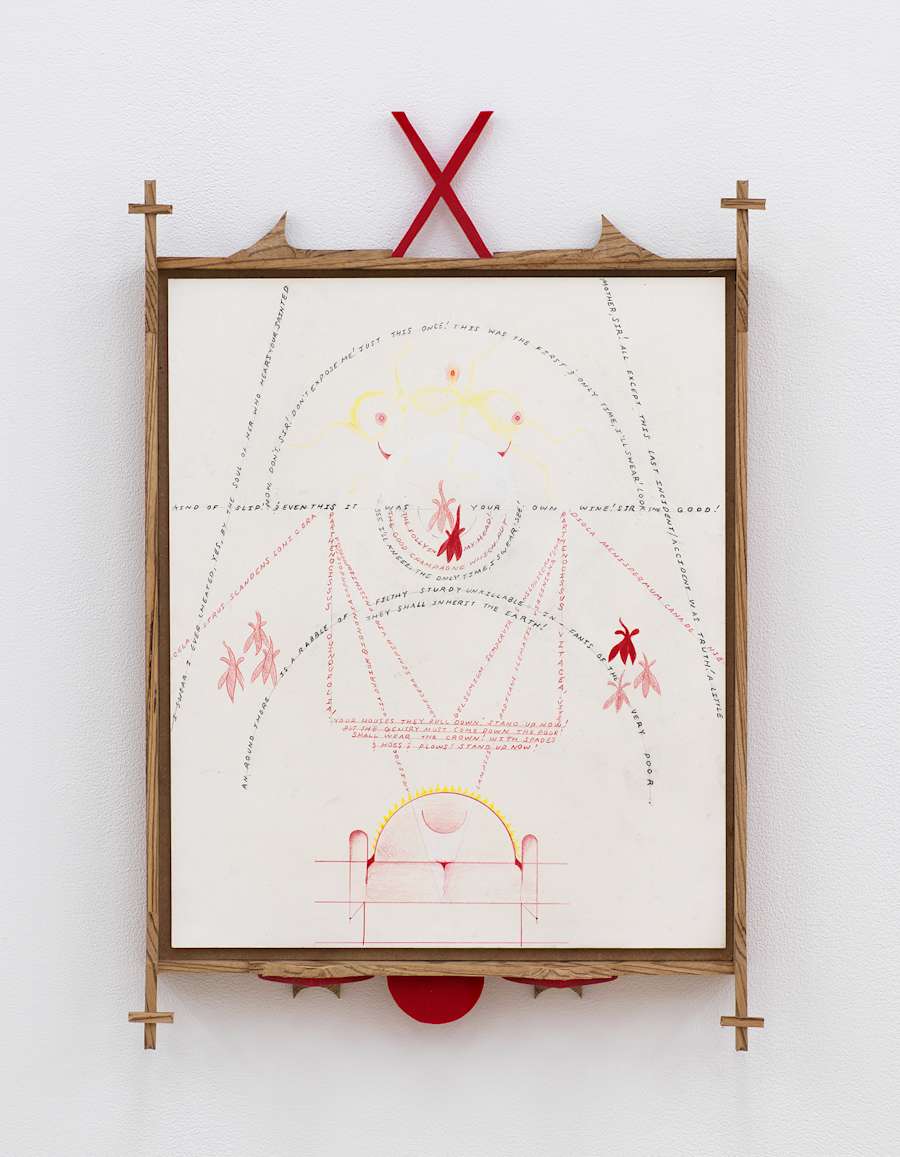 Image of Harry Gould Harvey IV drawing framed in foraged walnut wood, depicting lines of text criss-crossing the drawing, including depictions leaves, with decorative pieces of carved walnut crosses and red plexiglass attached to the top and bottom of the frame.