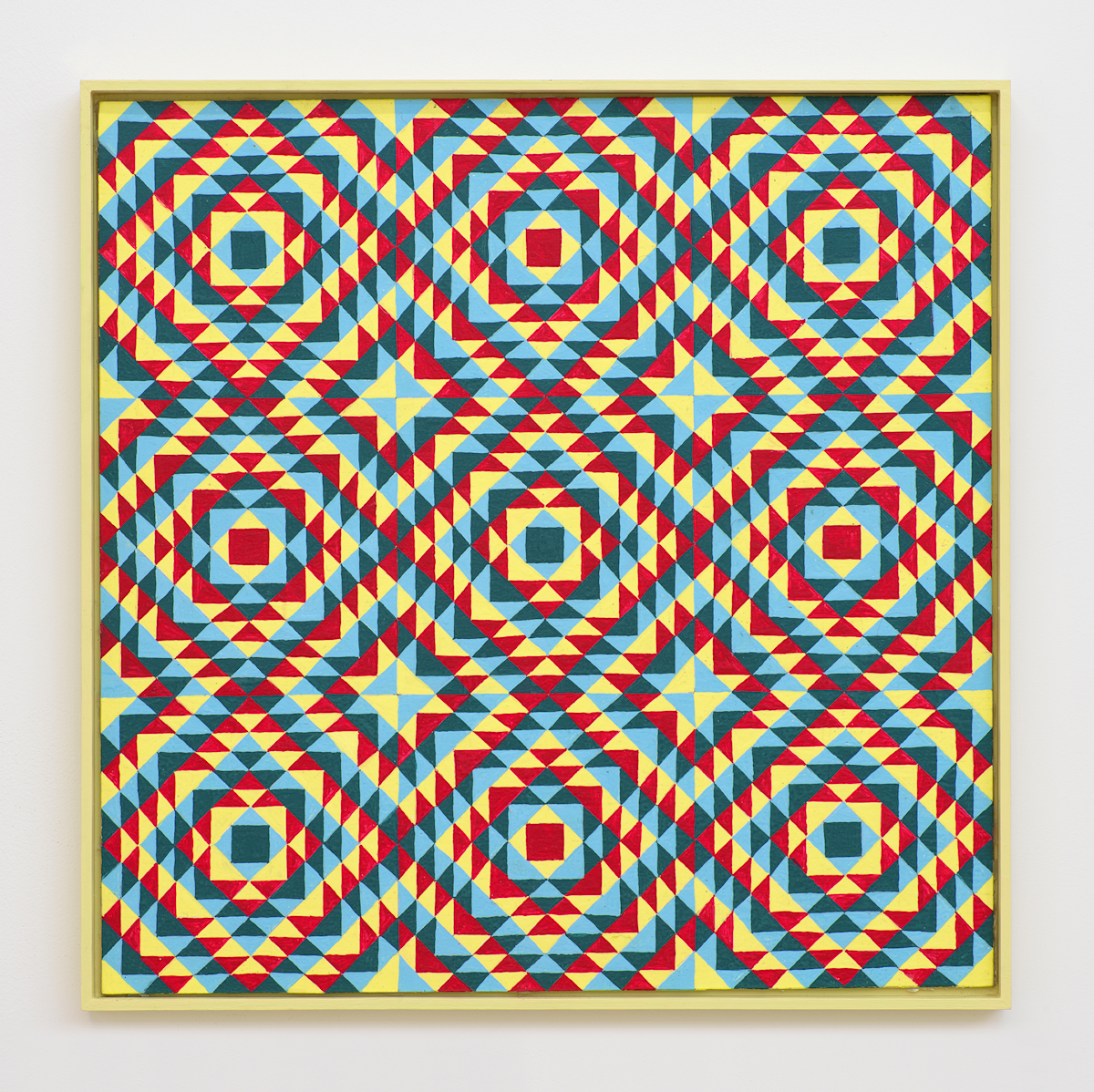 On a white wall a painting depicting a grid of crisscrossing lines generating many repeating rectangles, and triangles. The dominant colors are hues of yellow, red, and blue. The frame is painted yellow.
