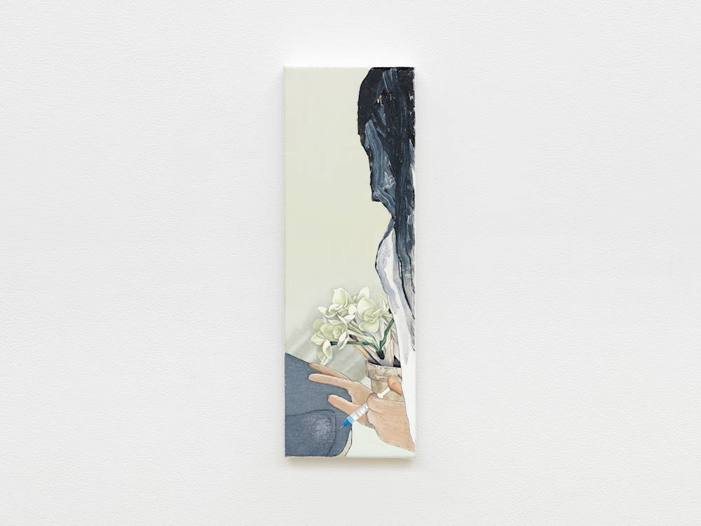 Installation view of a small narrow vertical painting. It has an off white background and an abstracted black head of hair along the right side with a white sleeved shoulder beneath the hair. A terra cotta pot of white flowers is central and painted very realistically. In front of that are two white hands, painted simply but realistically with black outlines one has a syringe in it and appears to be injecting an animal in the rear with the needle.