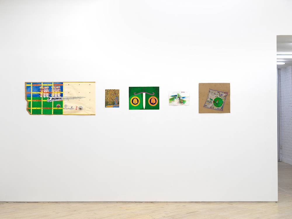 In a gallery space, a series of small works on paper are installed close together on a white wall. The drawings are clustered in a group. The drawings depict abstracted, cartoon-like character scenes. The sizes of the paper vary in length and proportion. There are interior spaces and exterior spaces depicted. The drawing on the left hand side depicts a moving train.
