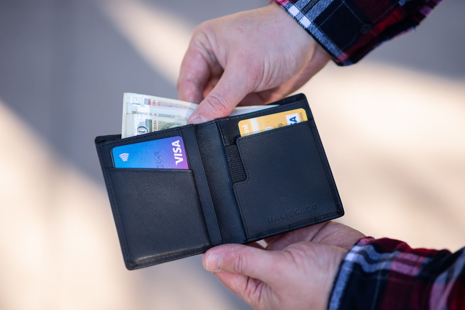 wallet person getting credit card to pay