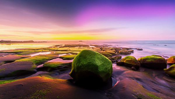 A beautifully edited photo of a rocky landscape, with unusual purple hues on the horizon. A beautifully edited photo of a rocky landscape, with unusual purple hues on the horizon.