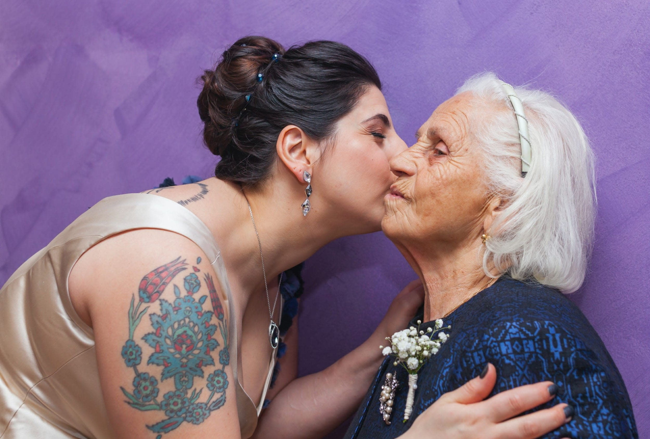 woman kissing grandmother on cheek 