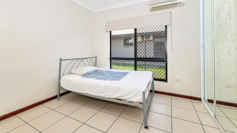 Tiled bedroom with a double bed and mirrored wardrobe.