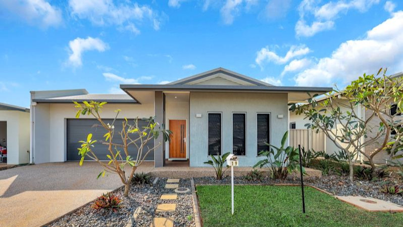 Front of home, paved path, grass, driveway.