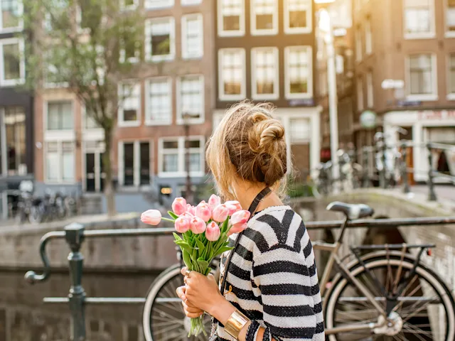 netherlands-amsterdam-canal-woman-flowers-swiper-hero-gallery
