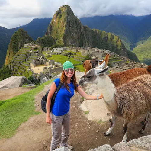 female-tourist-llamas-at-Machu-Picchu-overlook-in-Peru- expatexplore