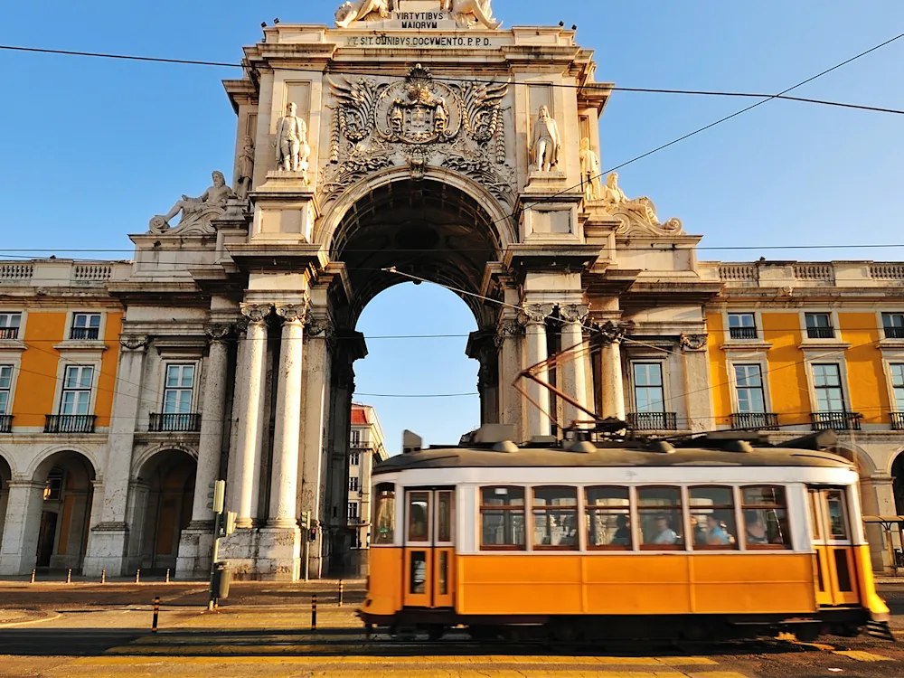 lisbon-portugal-yellow-train-arco-da-rua-augusta-swiper-hero-image