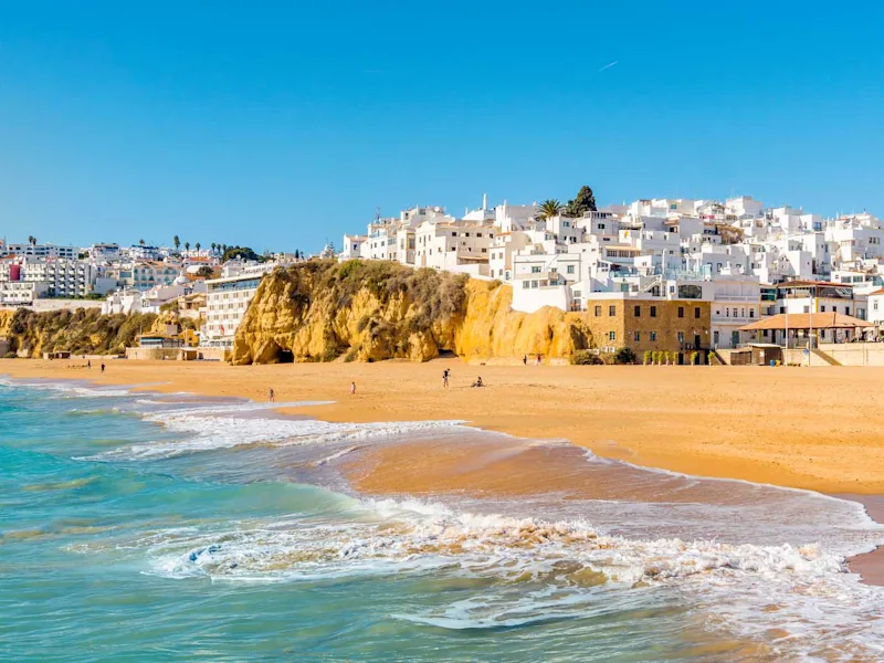 Wide-sandy-beach-in-white-city-of-Albufeira-Algarve-Portugal