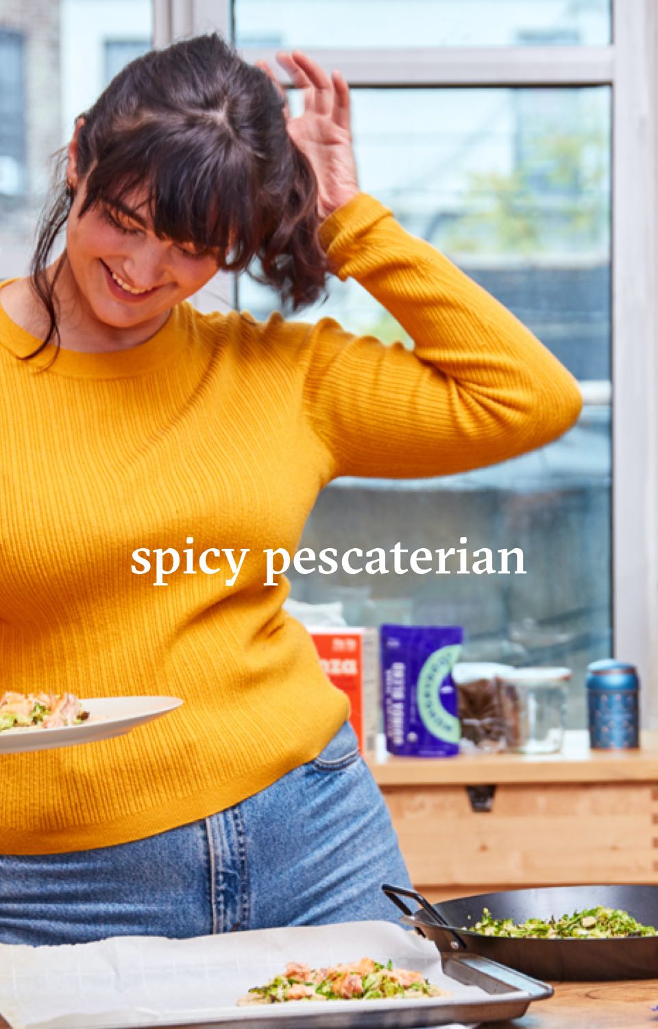 Woman in kitchen eating food. Headline reads Spicy Pescaterian