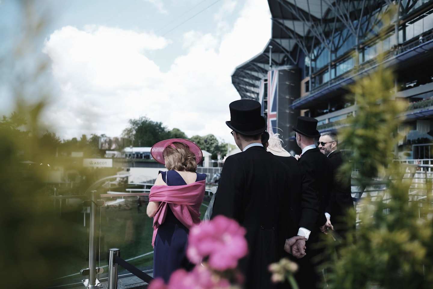 People watching on at Royal Ascot wearing smart clothes, Berkshire, UK
